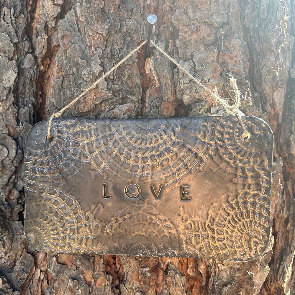 "love" hanging ceramic sign in gold with doily lace border