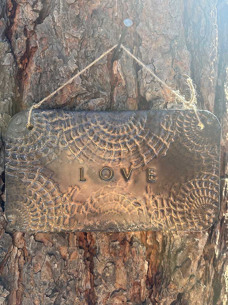 "love" hanging ceramic sign in gold with doily lace border