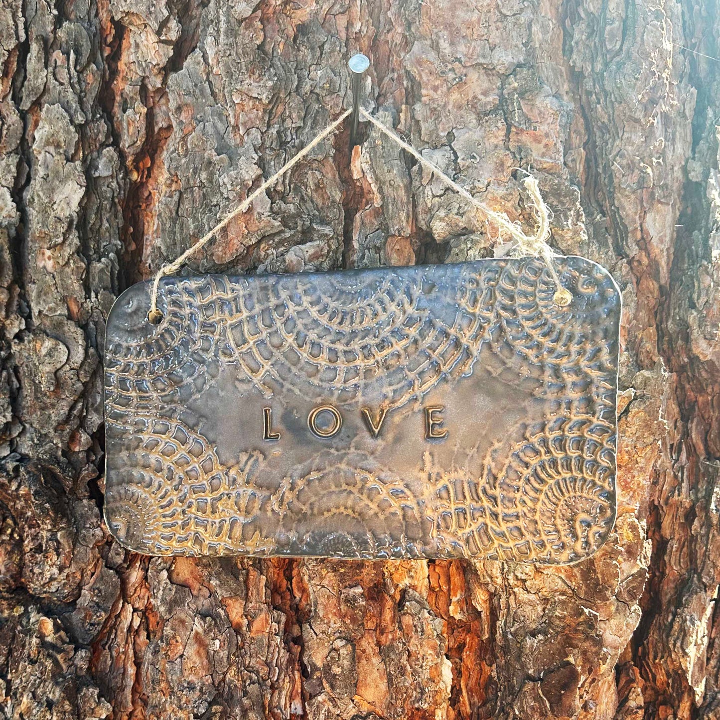 "love" hanging ceramic sign in gold with doily lace border