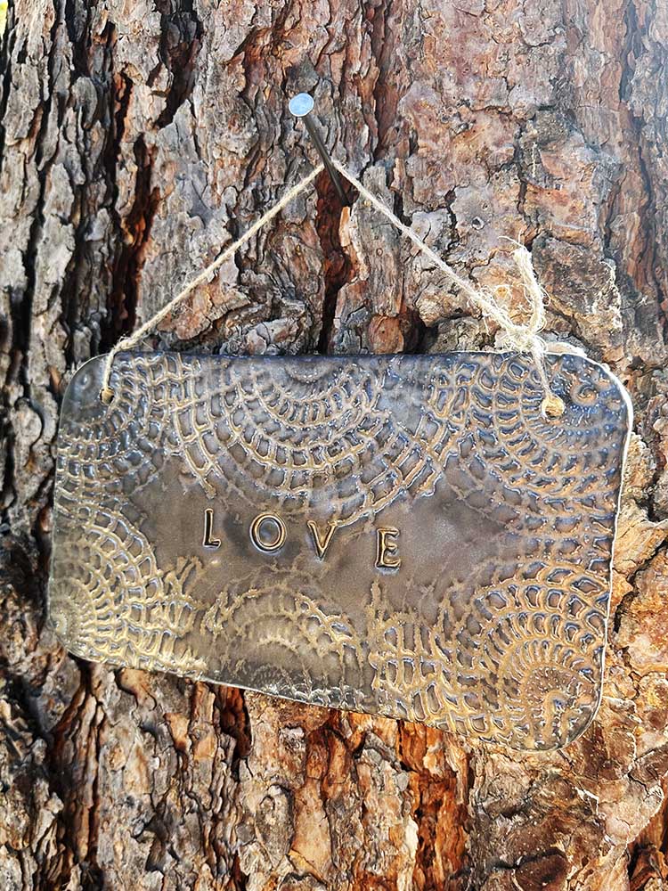 "love" hanging ceramic sign in gold with doily lace border