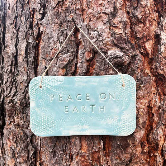 'peace on earth" hanging ceramic sign in blue lagoon with all-over doily lace imprint