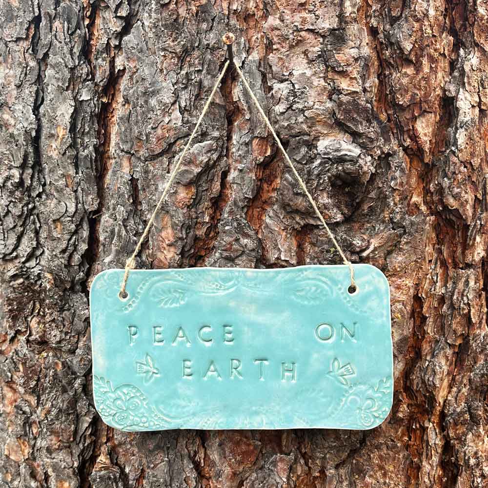 "peace on earth" hanging ceramic sign in blue lagoon with doves and doily lace border