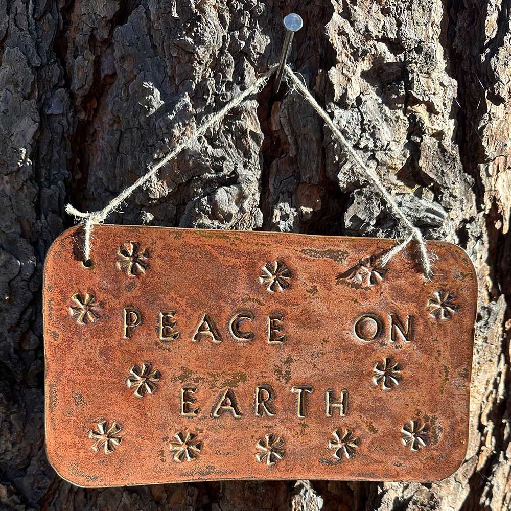 "peace on earth" hanging ceramic sign in ancient copper with asterisk stamp