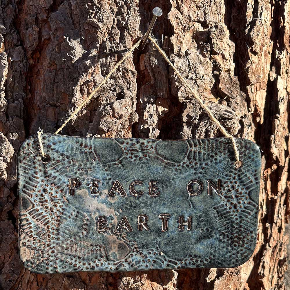 "peace on earth" hanging ceramic sign in sapphire with lace all-over print