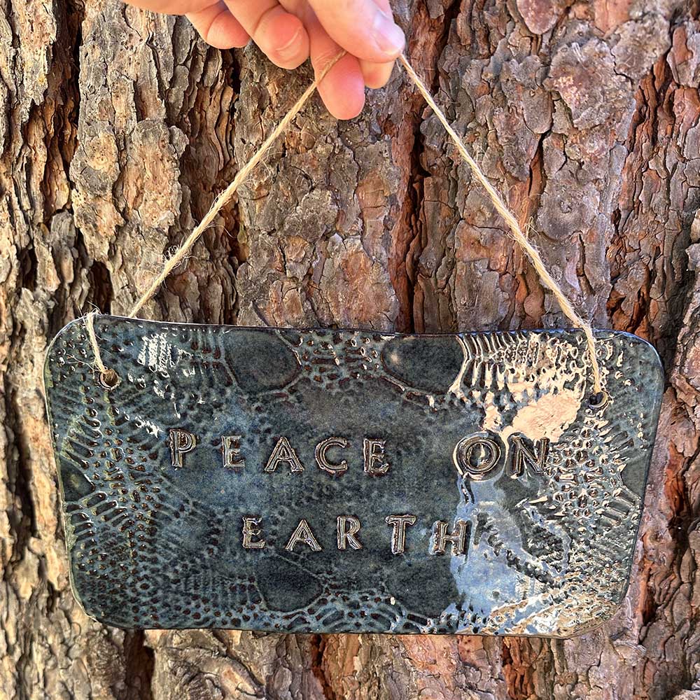 "peace on earth" hanging ceramic sign in sapphire with lace all-over print