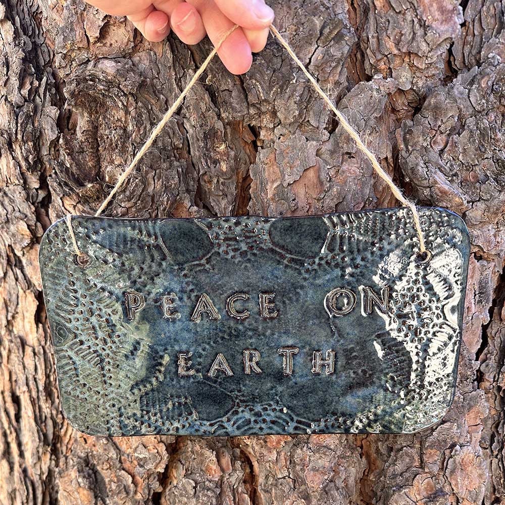 "peace on earth" hanging ceramic sign in sapphire with lace all-over print