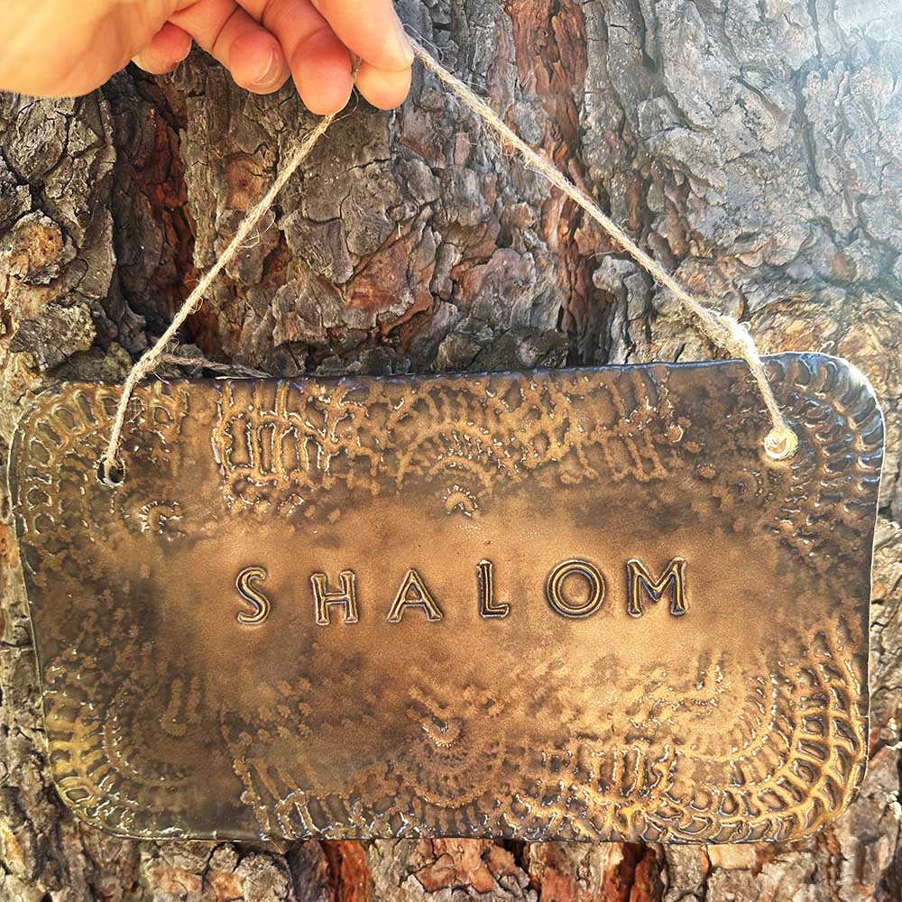 "shalom" hanging ceramic sign in gold with doily lace border