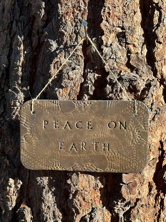 "peace on earth" hanging ceramic sign in gold with lace all-over imprint